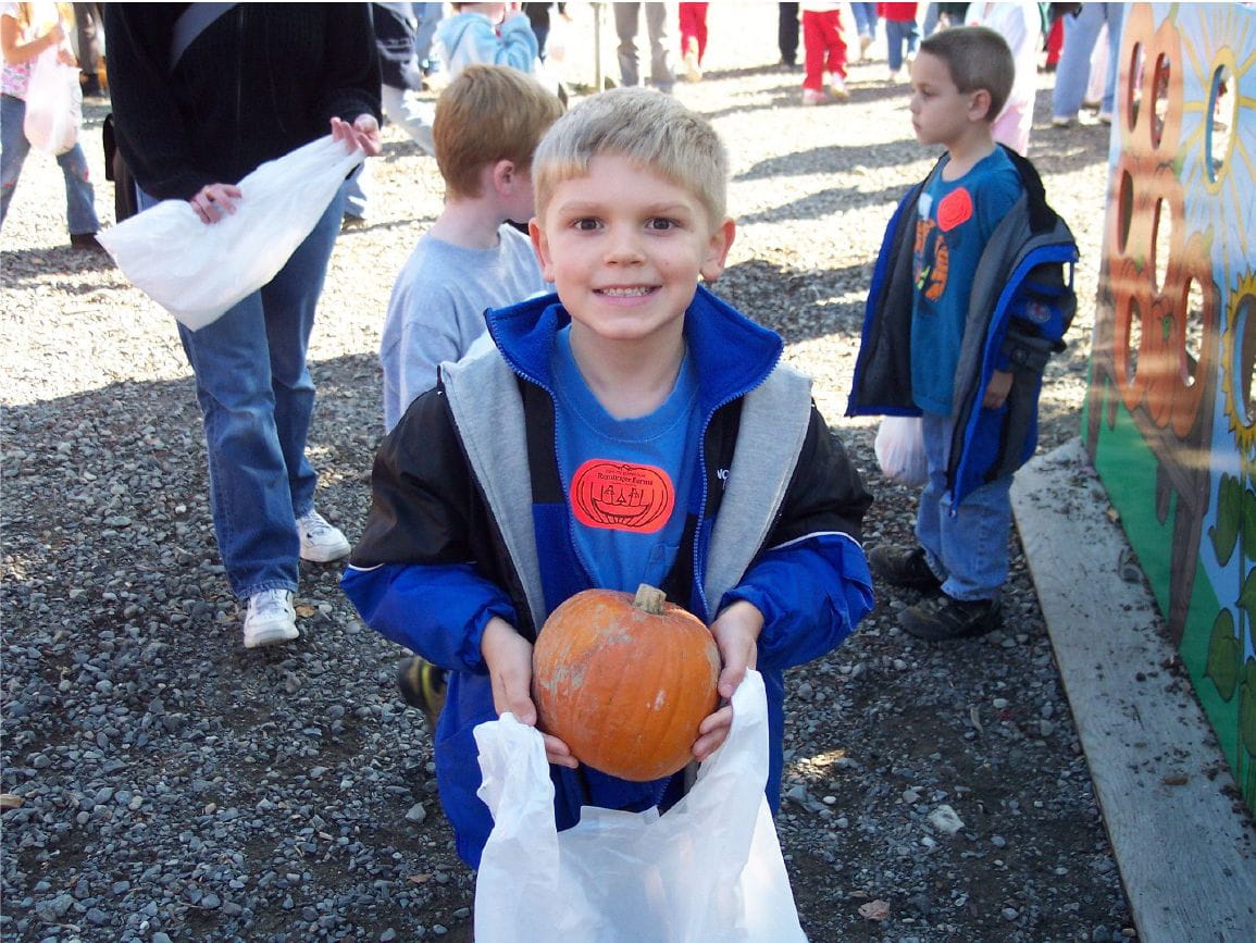 Child holding pumpkin