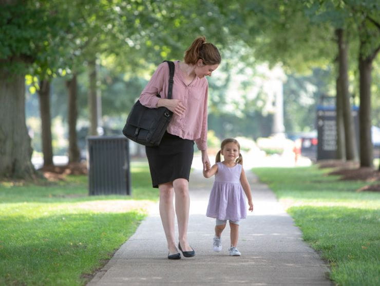 Working mom dropping daughter at daycare near work