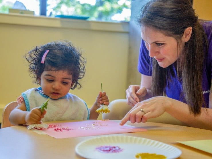 child and teacher playing