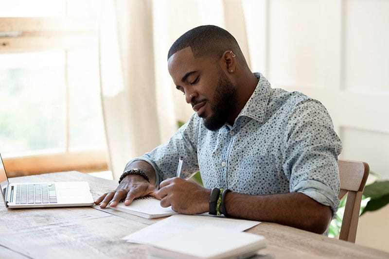 Young Black employee using his education assistance benefit