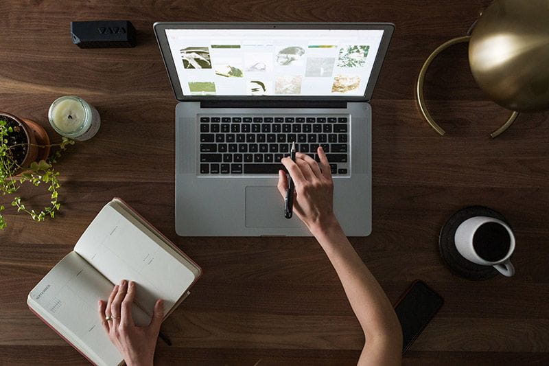 Bird's eye view of someone taking online classes on a laptop