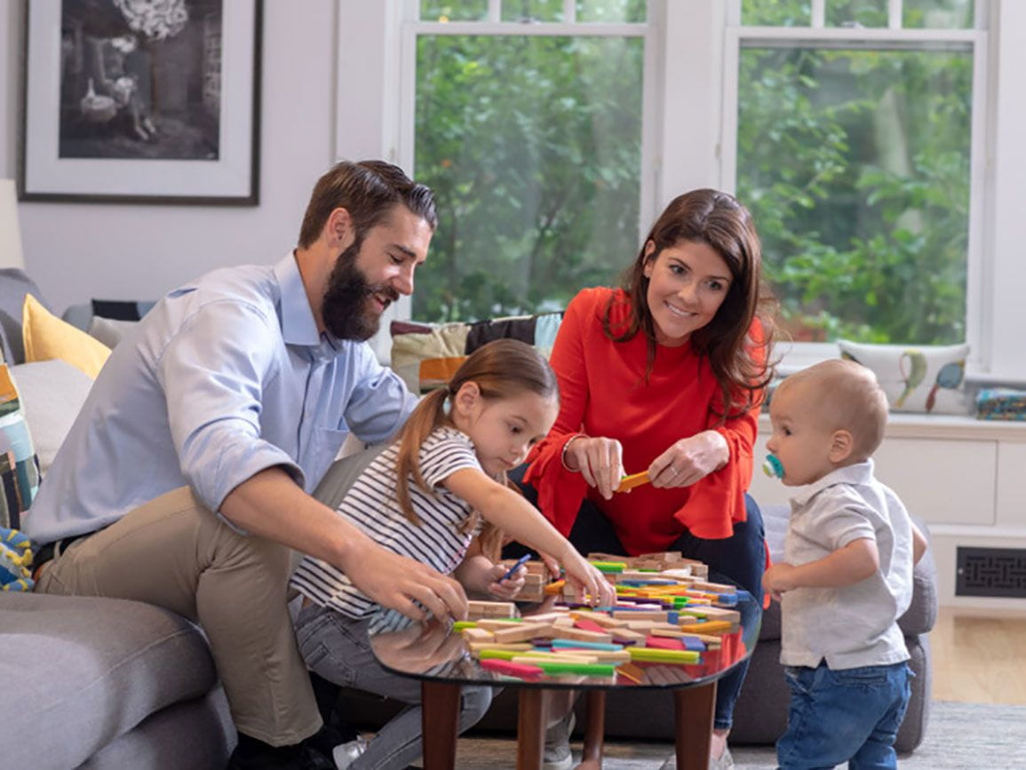 Family playing a game on the coffee together on a weeknight